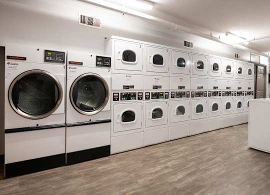 A row of washing machines in a laundromat.