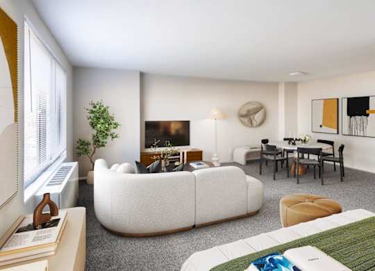 A living room with a white couch, a green rug, and a painting on the wall.