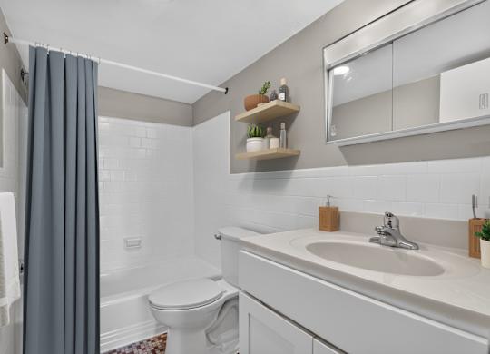 A bathroom with a white toilet and a white sink.