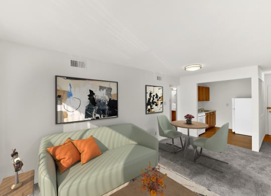 a living room with a green couch and a table with chairs