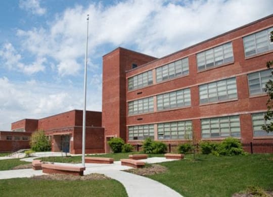 a large brick building with a flagpole in front of it