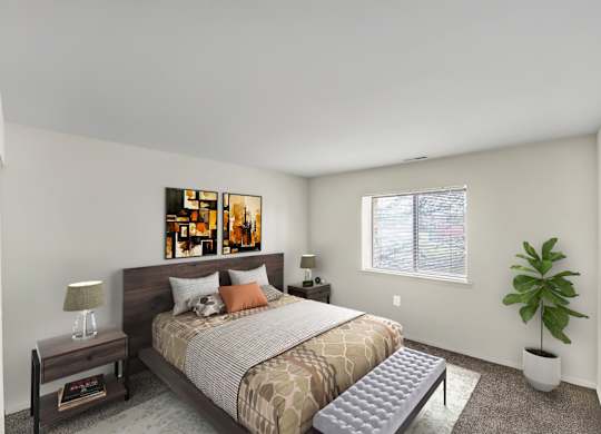 A bedroom with a bed, nightstand, and a plant.