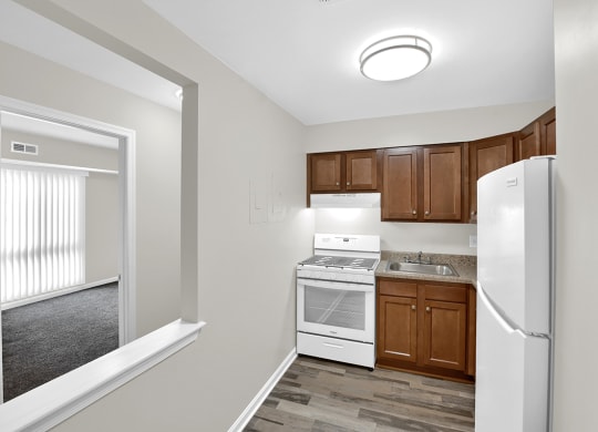 a kitchen with white appliances and wooden cabinets