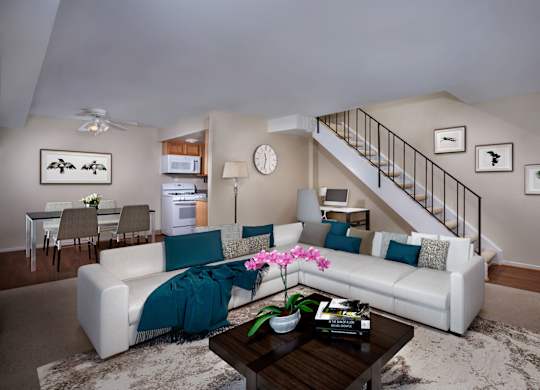 a living room with a white couch and a coffee table
