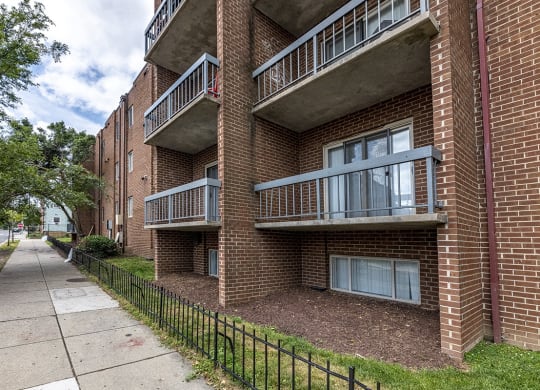 our apartments are located in a brick building with a sidewalk
