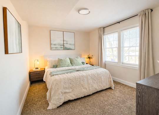 Bedroom with neutral tones and large windows at Highland Ridge Apartments, Capitol Heights, 20743