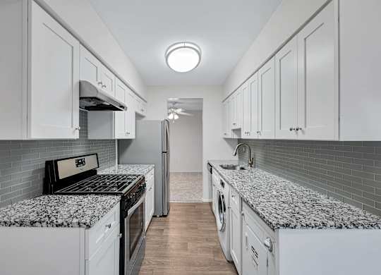 Kitchen with refrigerator and white cabinets at Aspen at Lake Trail, Maryland, 21045