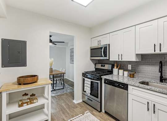 Modern kitchen with stainless steel appliances and white cabinets at Aspen at Lake Trail, Maryland, 21045