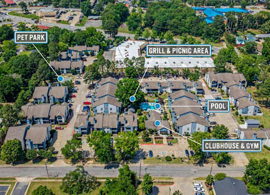 An aerial view of a residential area with a pool, clubhouse, and a grill & picnic area.
