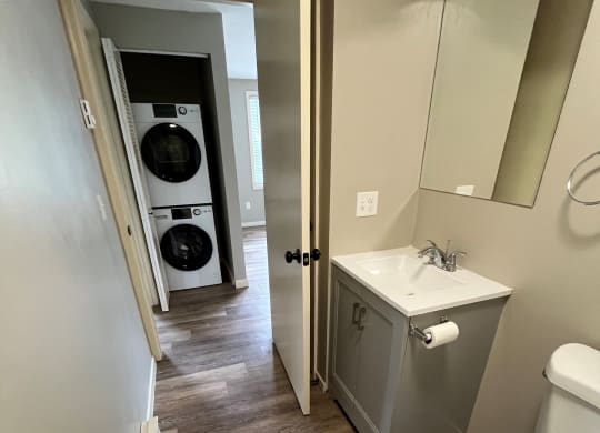 a small bathroom with a toilet sink and washer and dryer at Briarcliff at Quechee, Vermont, 05059