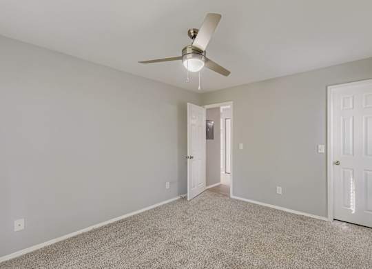 Empty room with a ceiling fan and carpeted floor at Keita 1875, Georgia