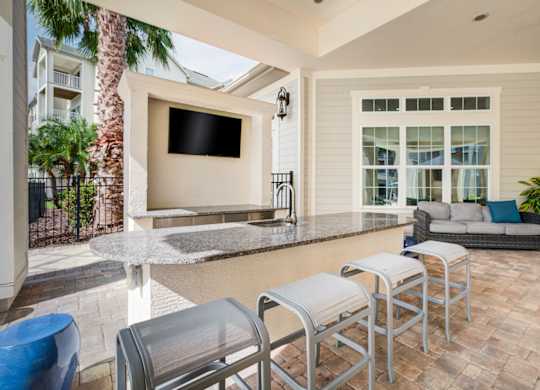 a patio with a bar and a couch  at Century Avenues, Lakeland, FL, 33813