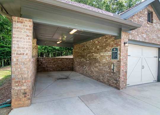 the garage of a house with white doors and a cement driveway at Century New Holland, Gainesville, GA