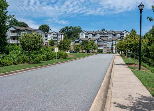 an empty street with apartment buildings on the side of it  at Century New Holland, Georgia