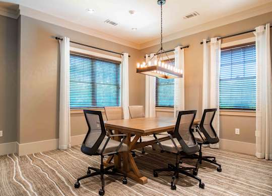 a dining room with a table and chairs and a chandelier at Century New Holland, Gainesville, Georgia