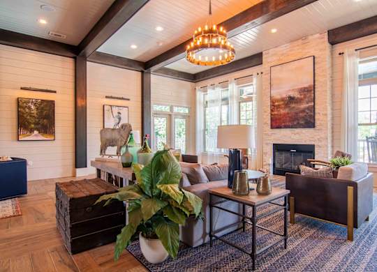 a living room with a couch and a fireplace at Century New Holland, Gainesville