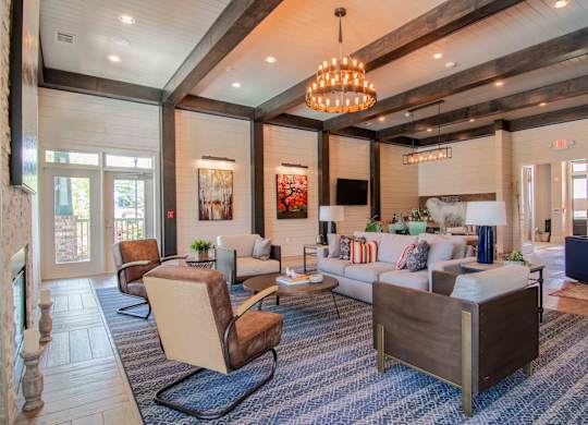 a living room with couches and chairs and a fireplace  at Century New Holland, Gainesville