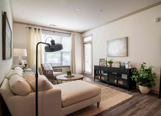 a living room with a couch and a table  at Century New Holland, Gainesville, 30501