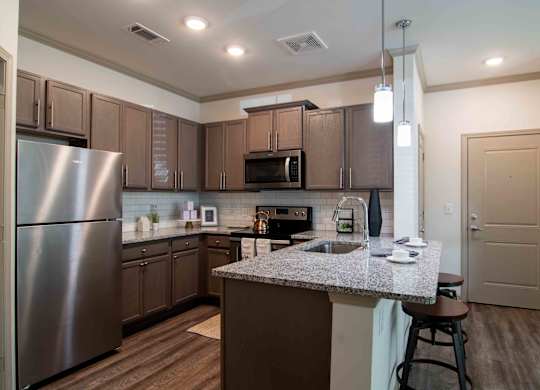 a kitchen with stainless steel appliances and granite counter tops at Century New Holland, Gainesville, GA, 30501