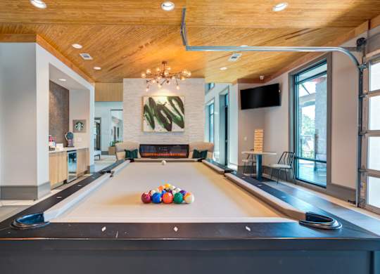 a pool table with balls on it in a large room with a fireplace at Century Town Center, Florida