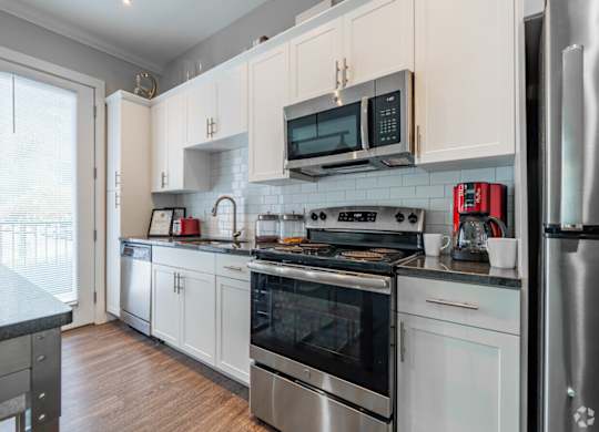 A kitchen with white cabinets and stainless steel appliances.at Century Baxter Avenue, Louisville, 40204