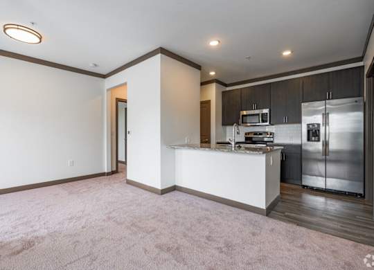 A kitchen with a white counter and stainless steel appliances. at Century Belmont Station, Louisville, KY