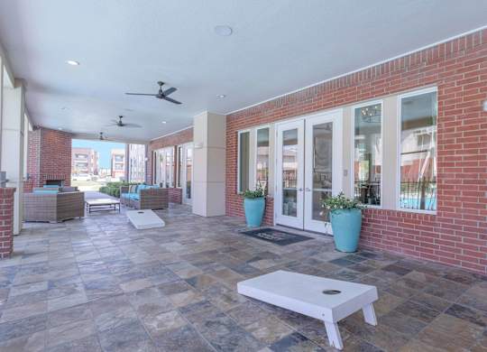 a patio with a white coffee table in front of a brick building at Century Palm Bluff, Portland