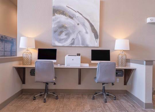 a desk with two computers and two lamps in a room at Century Palm Bluff, Portland, TX, 78374