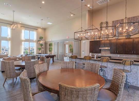 a large dining room with tables and chairs and a kitchen at Century Palm Bluff, Portland, Texas