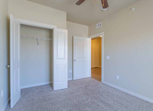 a bedroom with a closet and a ceiling fan at Century Palm Bluff, Portland, TX, 78374