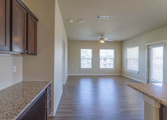 the view of a living room from the kitchen of an empty house at Century Palm Bluff, Portland