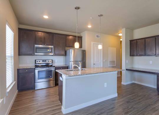 a kitchen with a large island and a stove and a refrigerator at Century Palm Bluff, Portland, TX