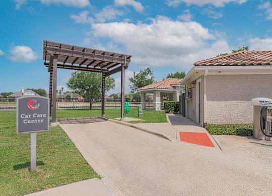 the entrance to the car care center at the whispering winds apartments in pearland, tx at Century South Shore Apartments, League City, 77573