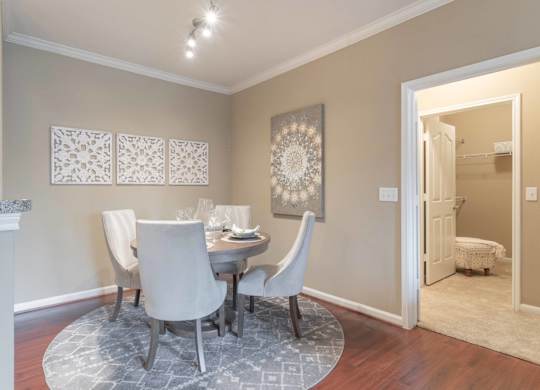 a dining room with a table and chairs at Century South Shore, League City, TX
