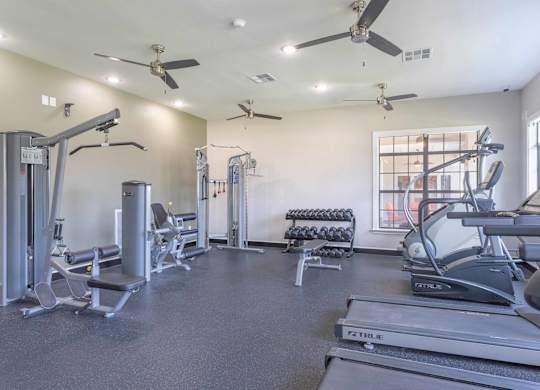 gym with cardio equipment at the whispering winds apartments in pearland, tx at Century South Shore, League City, TX