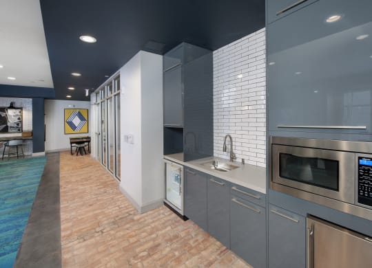a kitchen with gray cabinets and a brick floor at Marley EAV, Atlanta, GA, 30316