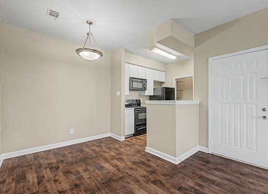 A kitchen area with a white door and a white cabinet.