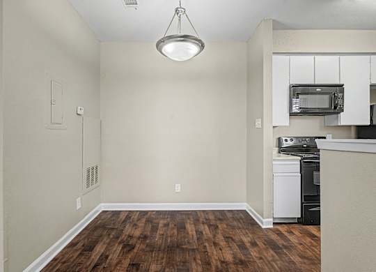 A kitchen area with a dishwasher and microwave.