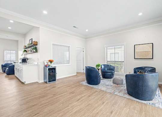 A living room with a white wall and a blue chair.