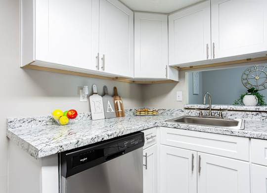 Kitchen with white cabinets and granite countertops at The Cobb Apartments-Townhomes, Austell, GA, Georgia, 30168