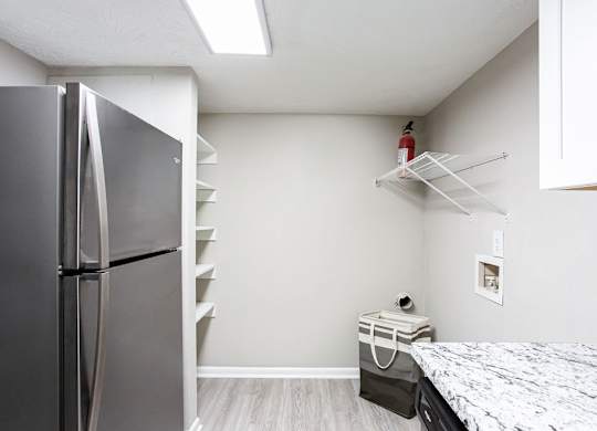 Kitchen with a refrigerator freezer next to a counter top at The Cobb Apartments-Townhomes, Georgia, 30168