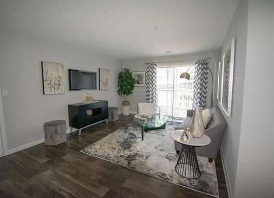 a living room with a couch and a television at The Sapphire, Georgia, 30035