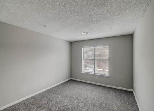 an empty living room with a window at The Sapphire, Decatur, 30035