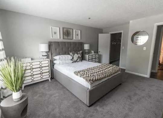 a bedroom with a large bed and a mirror at The Sapphire, Georgia