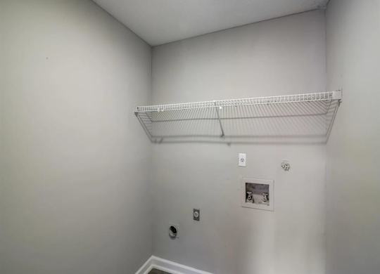 a empty room with a shelf on the wall at The Sapphire, Georgia, 30035