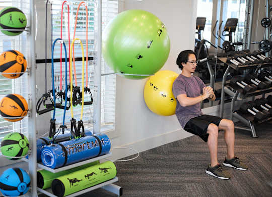 a man exercising in the gym at a health club at Century Mundy Mill Apartments, Oakwood 30566