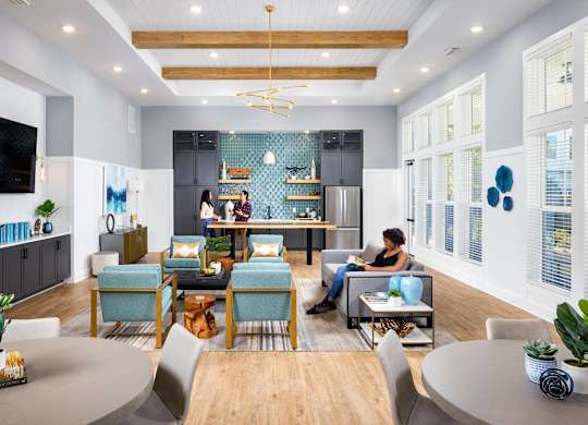 a living room filled with furniture and a kitchen at Century Mundy Mill Apartments, Oakwood, GA 30566