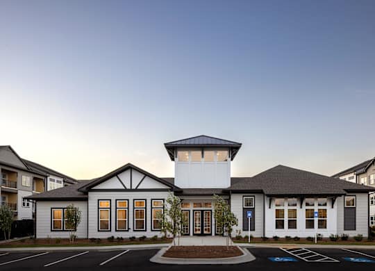 the exterior of a building with a parking lot at Century Mundy Mill Apartments, Georgia