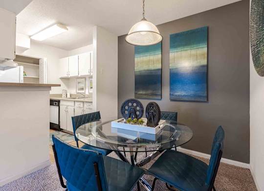 A dining room with a glass table and chairs. at Grove at St. Andrews, Columbia, South Carolina