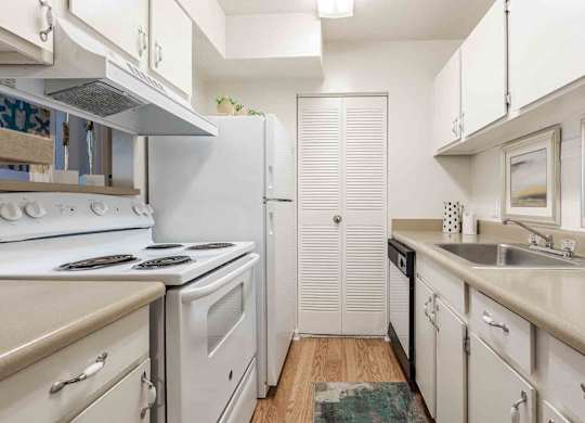 A kitchen with white appliances and cabinets. at Grove at St. Andrews, Columbia, SC, 29210
